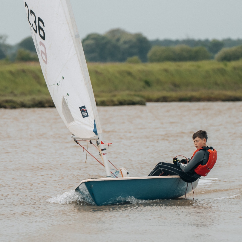 Boy in dinghy moving from right to left